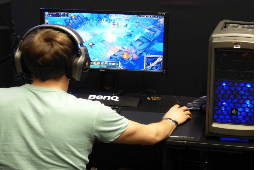 a child playing computer games wearing a grey shirt